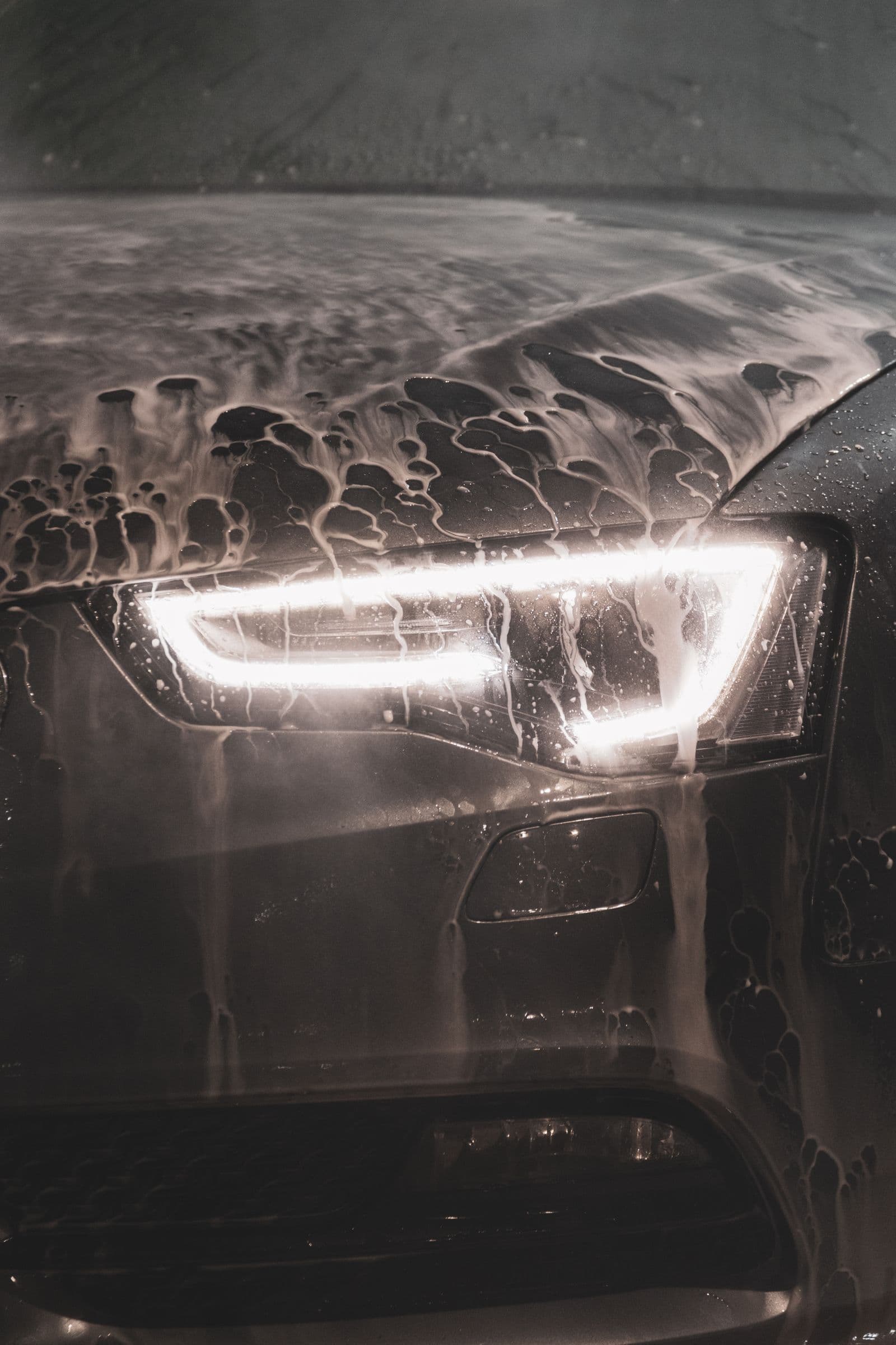 Foam sitting on a headlight before bug residue is lifted