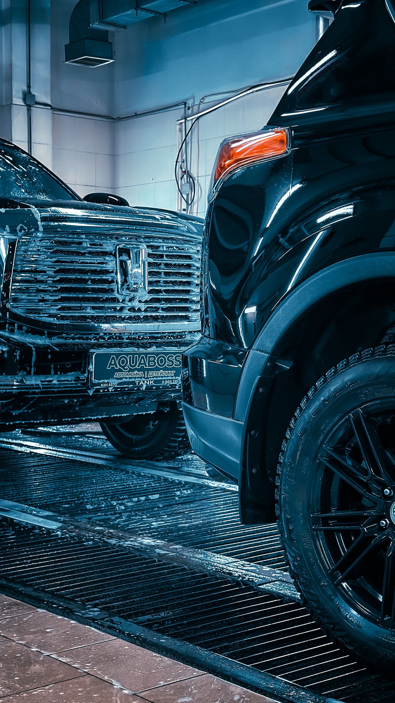 Several vehicles being cleaned in sequence, as on a fleet schedule