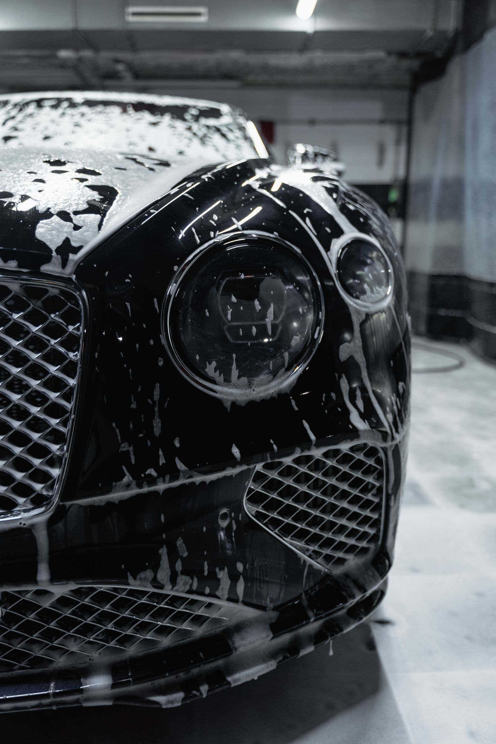 Soap suds across the shoulder line of a black car