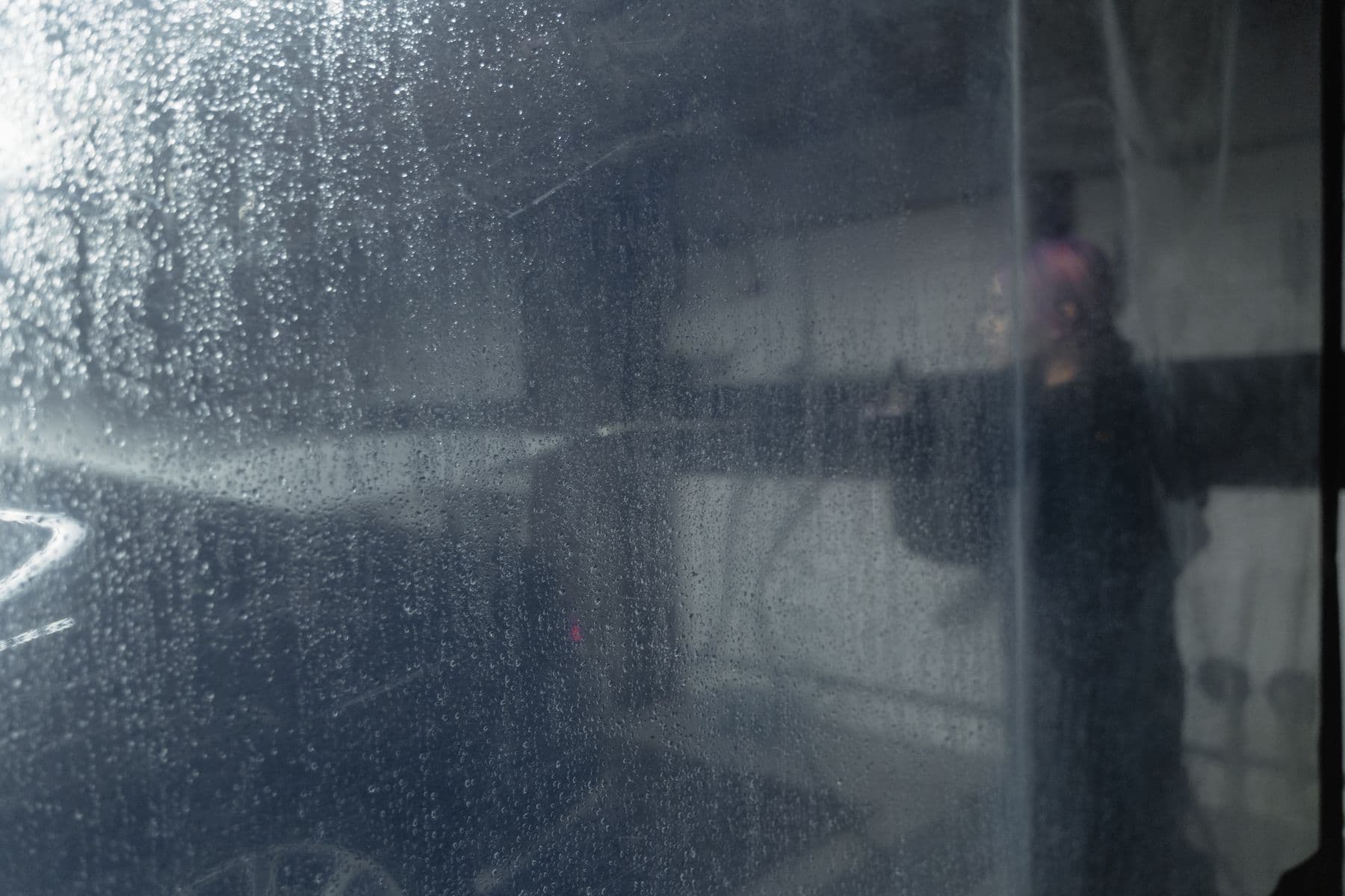 Foam covering the side of a car before the contact wash stage